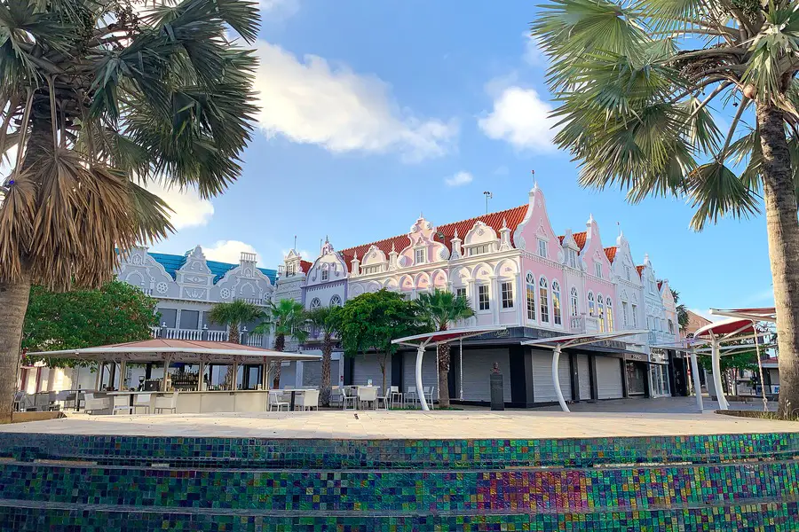 Palm trees and colorful Dutch Caribbean style buildings in Plaza Daniel Leo in Oranjestad, Aruba