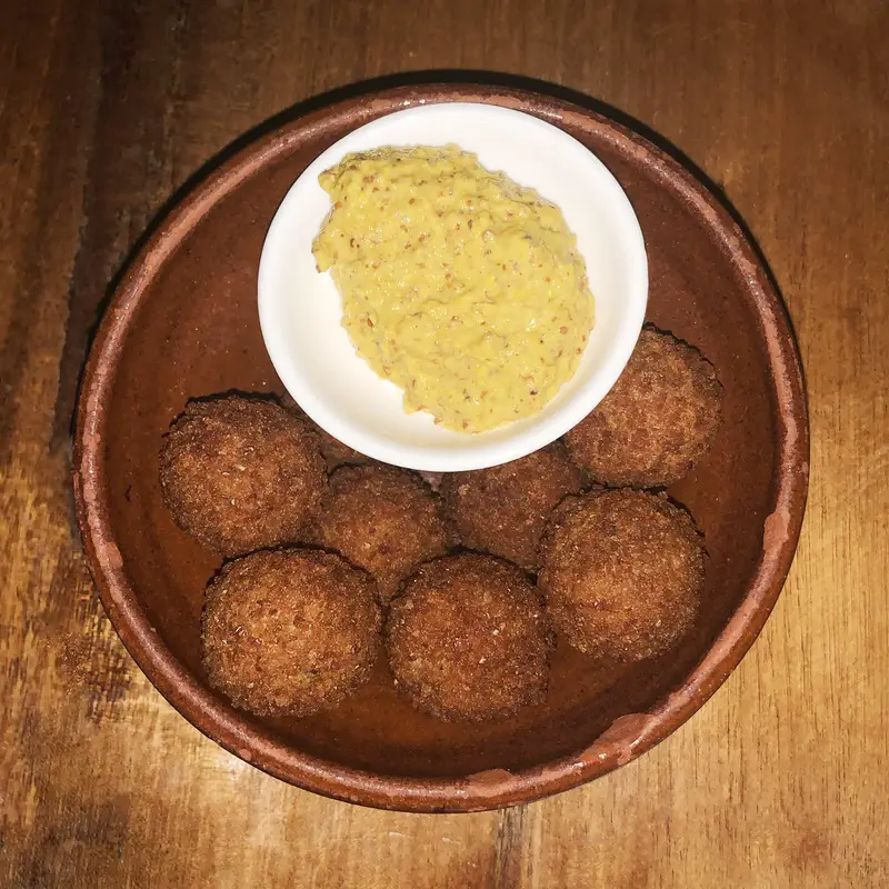 bowls of bitterballen and yellow mustard at Bistro de Suikertuin in Oranjestad, Aruba