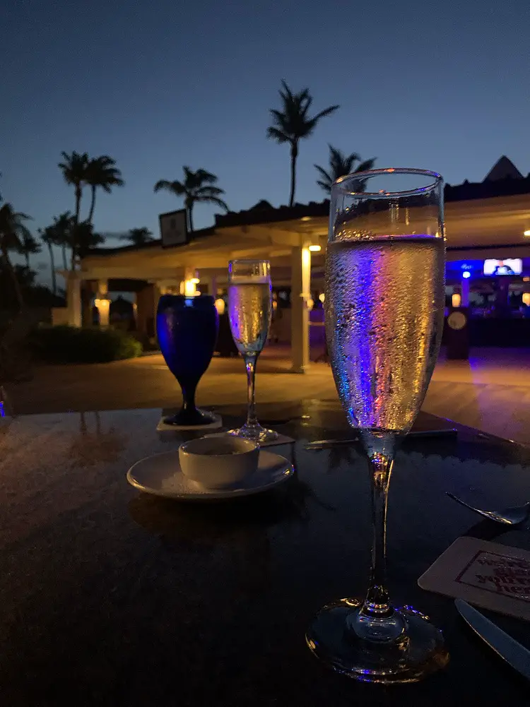 colored lights reflecting through a champagne flute at Ike’s Bistro in Aruba