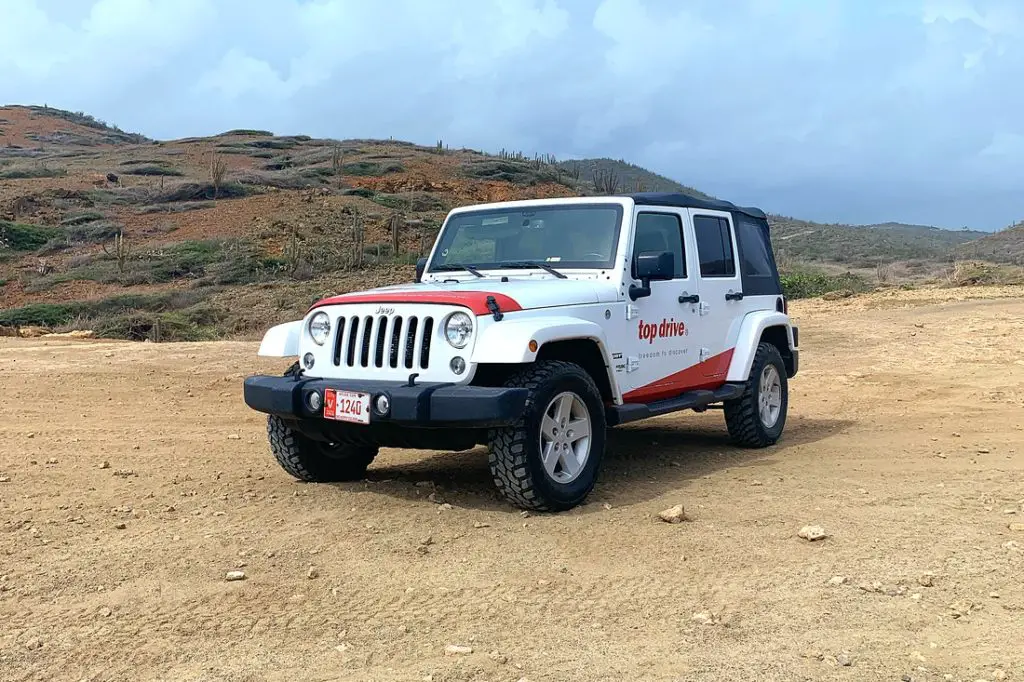 red and white Jeep near Andicuri Beach in Aruba