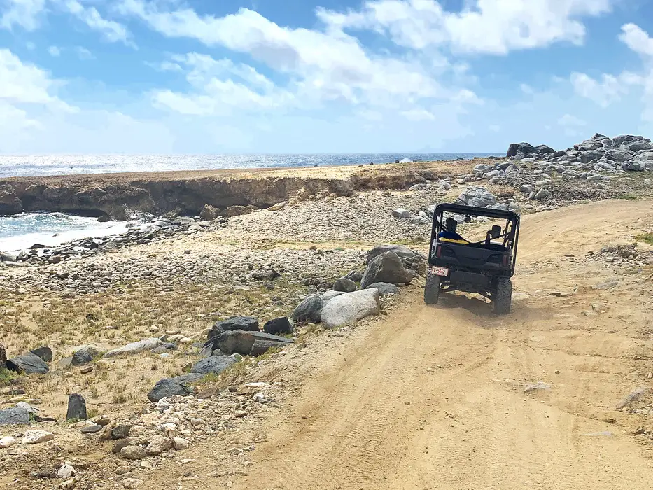all-terrain vehicle off-roading beside the ocean in Aruba