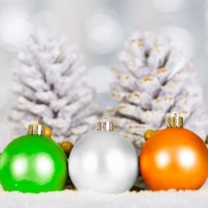 green, white, and orange Christmas ornaments with white pine cones