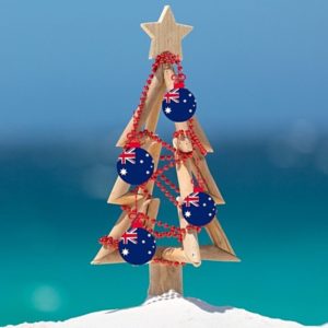 Christmas tree with Australia Christmas ornaments on a beach